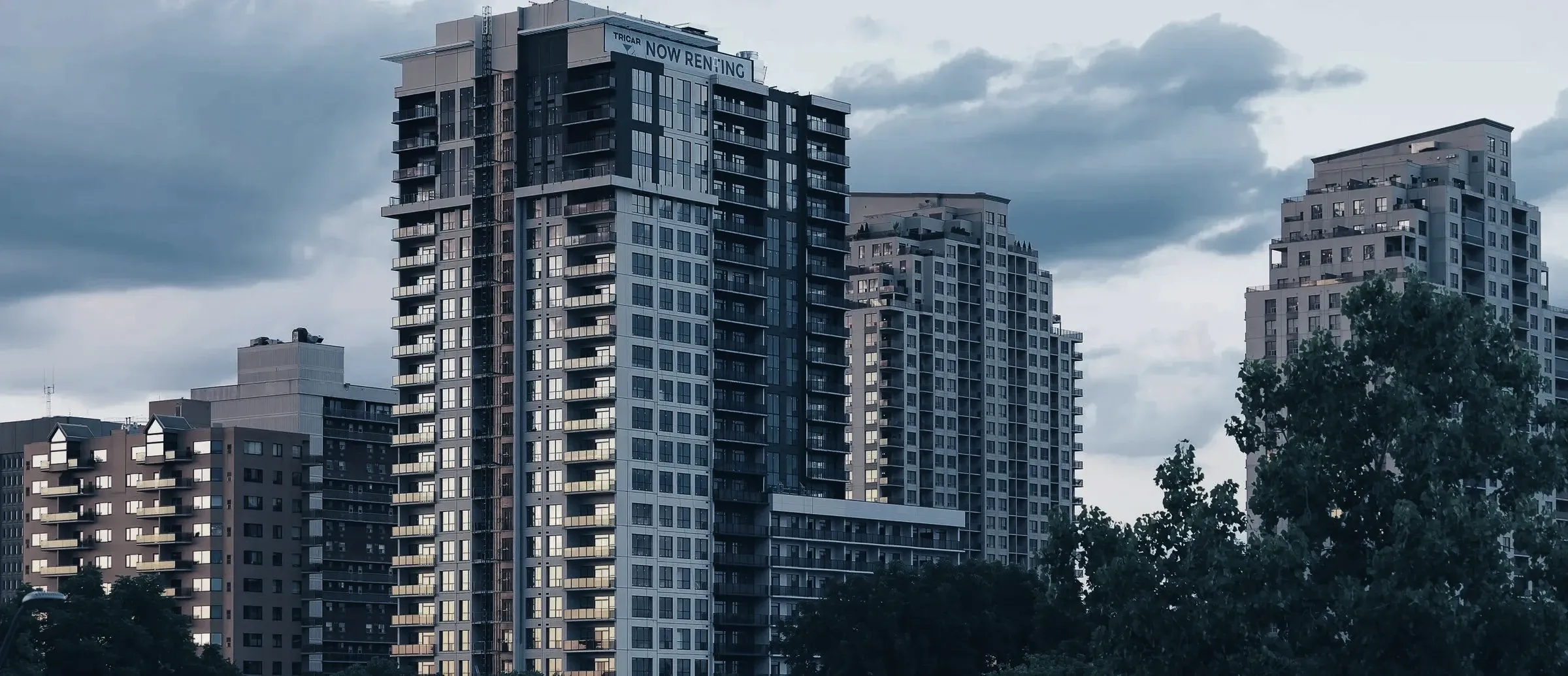 Downtown London towers above the trees along the Thames Valley Parkway